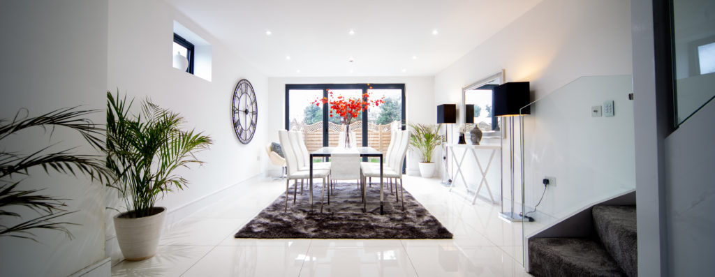 Large dining room with table and chairs on grey rug