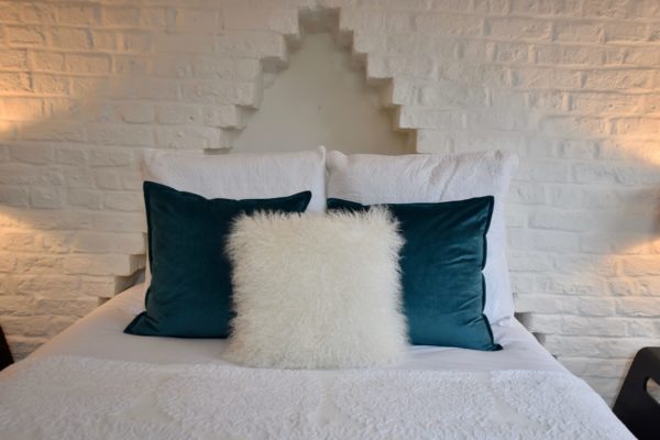 home staging blue and white cushions on bed