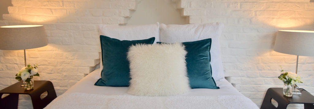 Bed with blue velvet cushions
